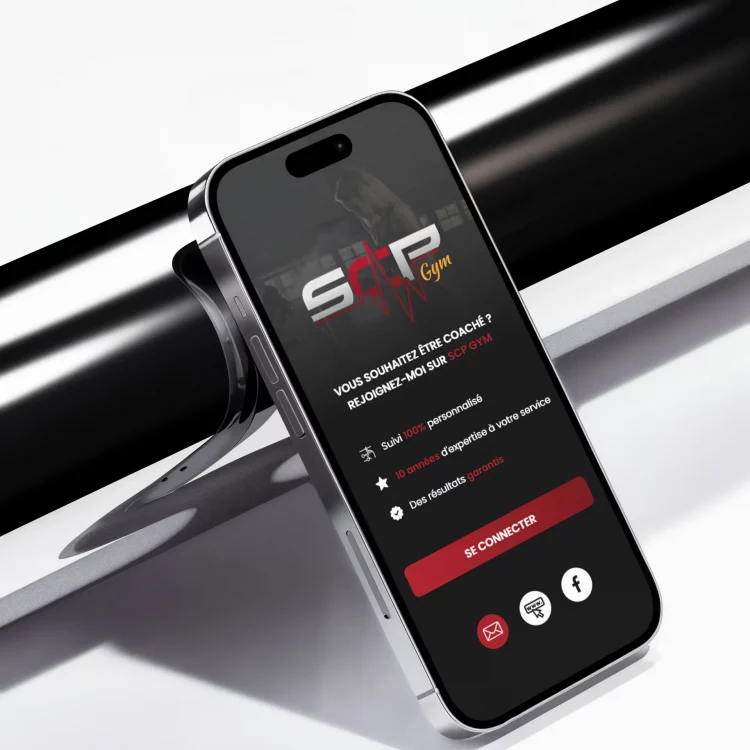 Un smartphone affichant une application de gym sur un support.